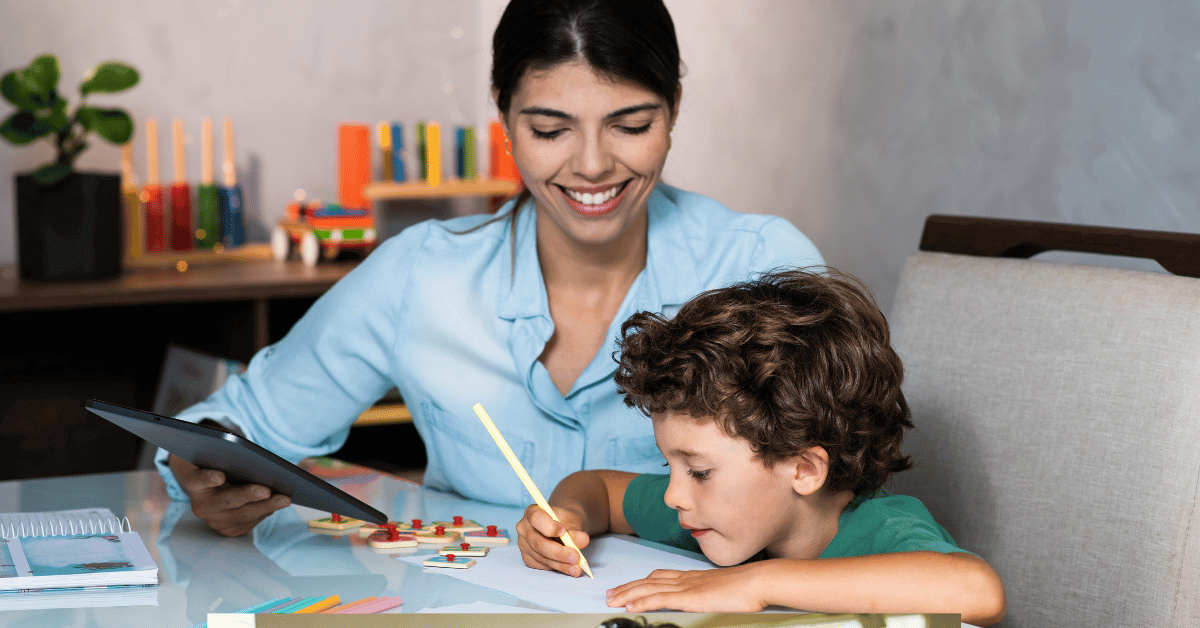 Parent supporting a young child while practicing English writing at home using simple learning tools.