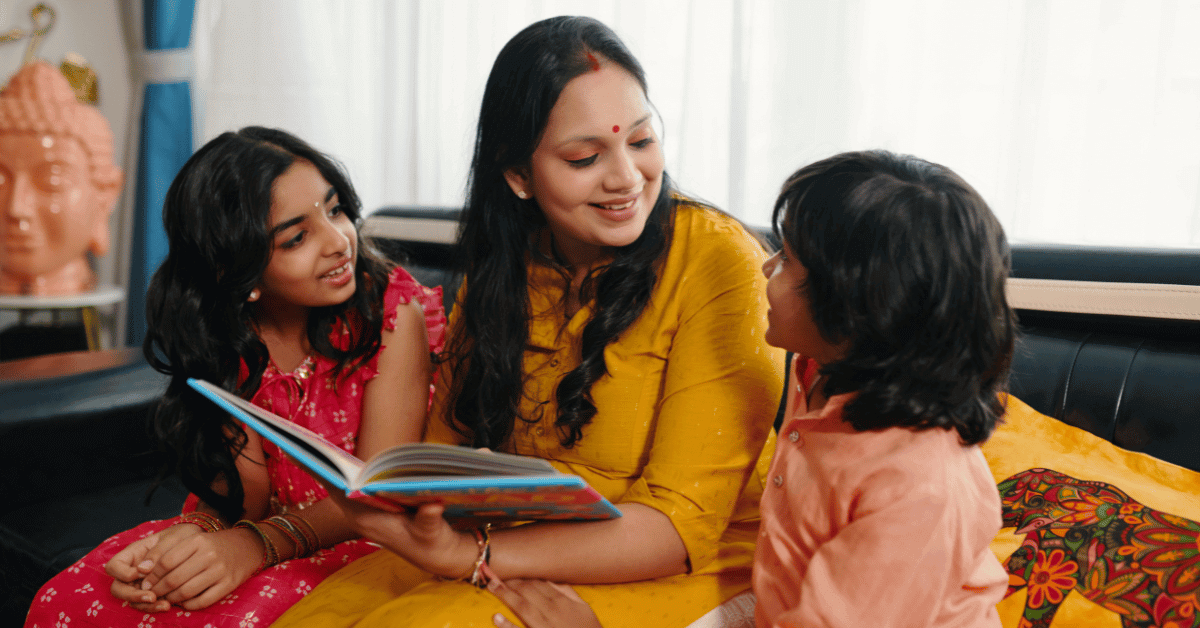 Indian mother helping her child read an English book at home in a calm and supportive learning environment
